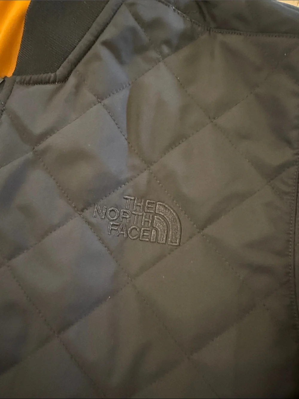 The North Face Men's Quilted Bomber Jacket in Black with Mustard reversible